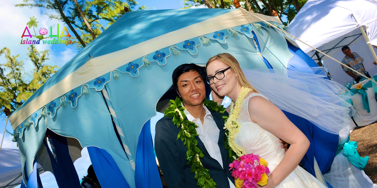 rachelle and her groom by the tent at beach reception