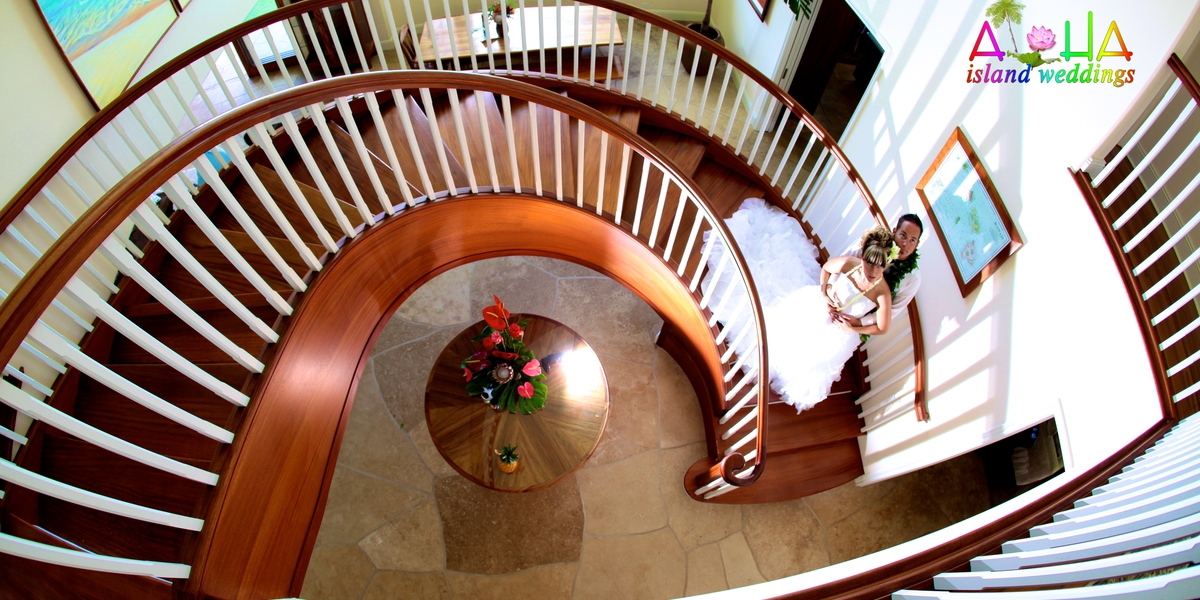 Spiral staircase seen from above with a flower arrangement in the entrance hall
