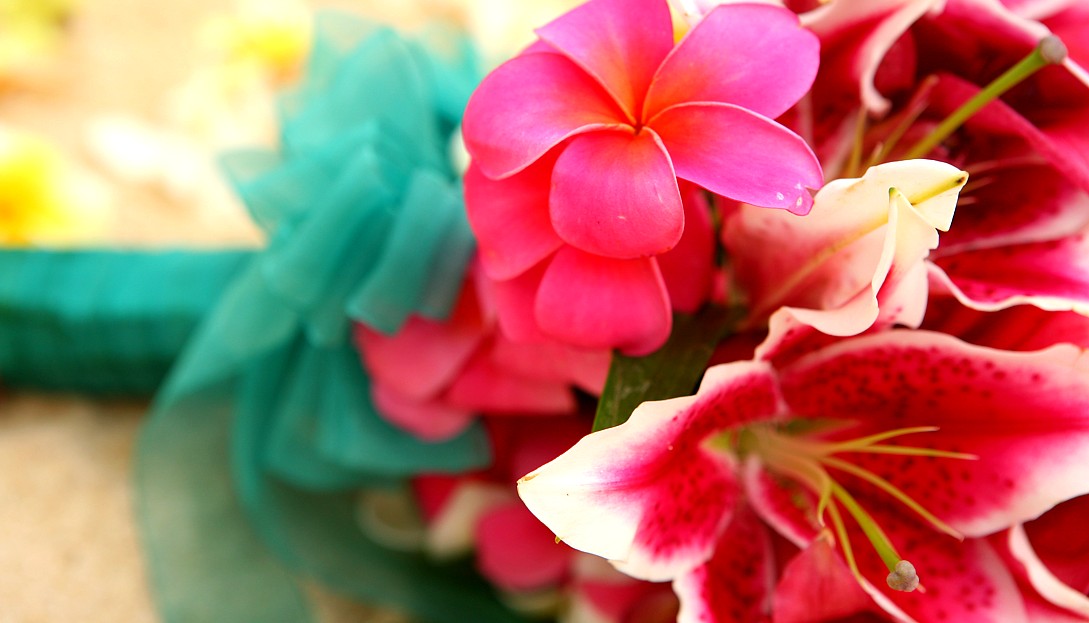 bright pink plumeria on a bouquet for a weding on the beach