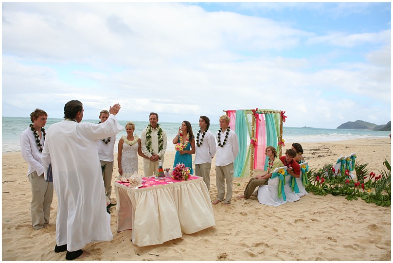 minister from Hawaii Alan Fisher lifting his hand to say a bllessing for the ten year vow renewal