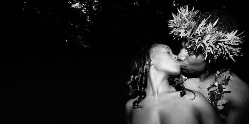 black and white photo of the newly weds kissing