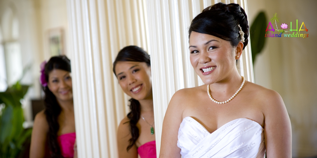 Smiling bride with her bridesmaids in pink dresses