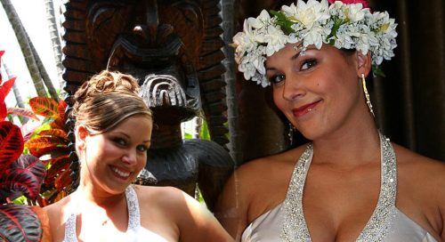 Bride wears a white and green flower head lei