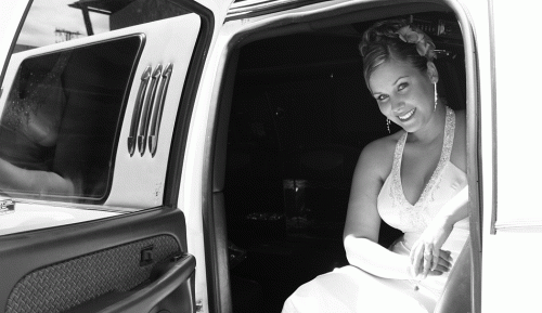 Bride arriving to her wedding in a limo black and white photo