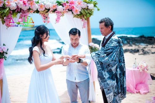 Wedding ring exchange guided by Kahu minister from Hawaii known as Kimo James