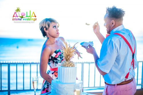 Cedric trying to feed his wife a piece of cake at their 5 year vow renewal