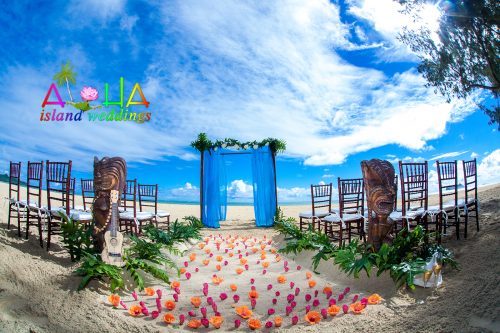 Hawaii beach wedding setup with blue sky material on a mahogany bamboo archway