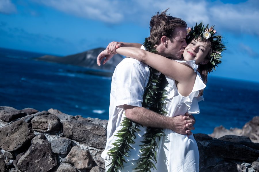 kiss by the cliffs of makapuu after wedding ceremony in Hawaii 