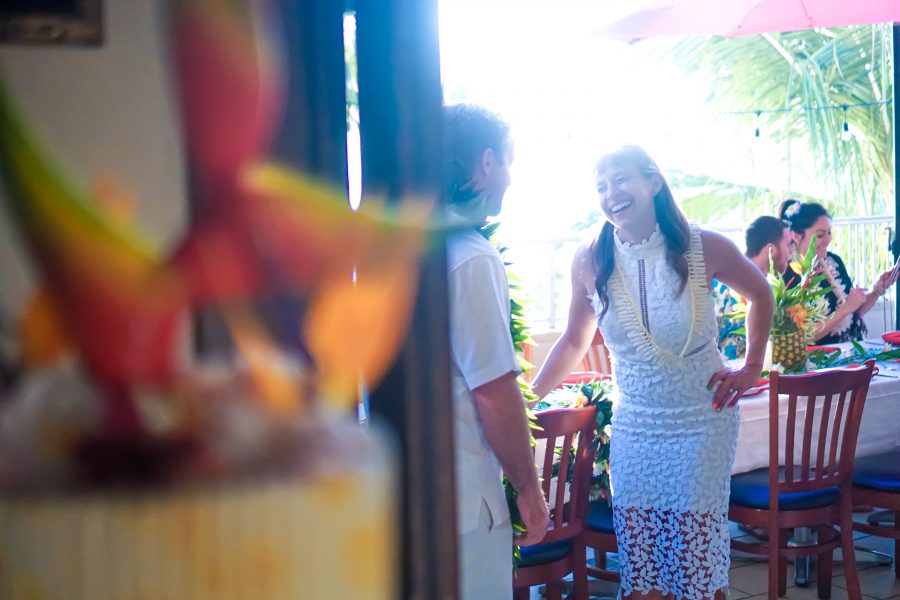bride laughs with her groom at the reception lanai area at tikis nar and grill
