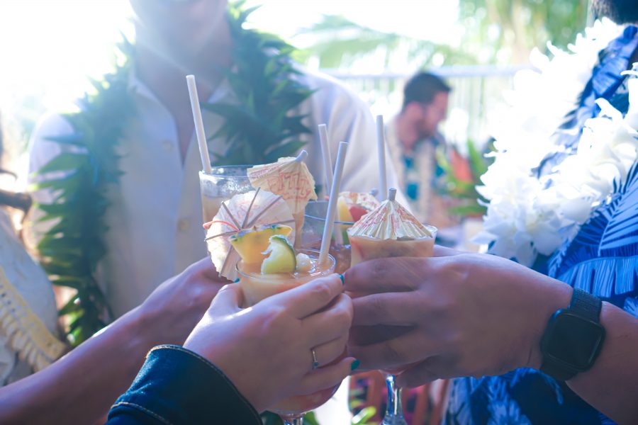 Toasting with friends at reception umbrella drinks