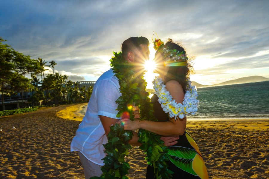 Hawaii proposal with the sun shinning through their kiss