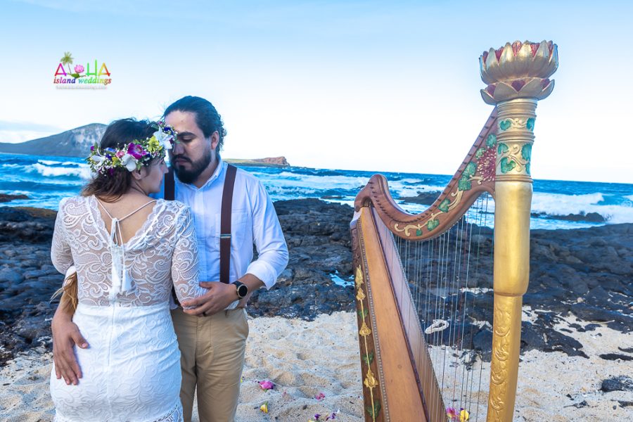 Newly married couple takes photos with beach harp