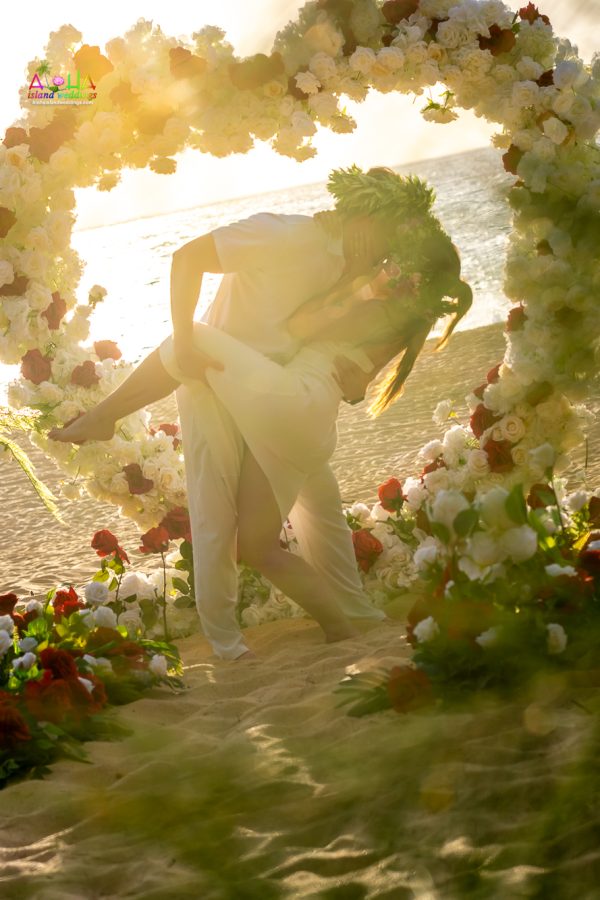 the engagement beach dip under the heart archway